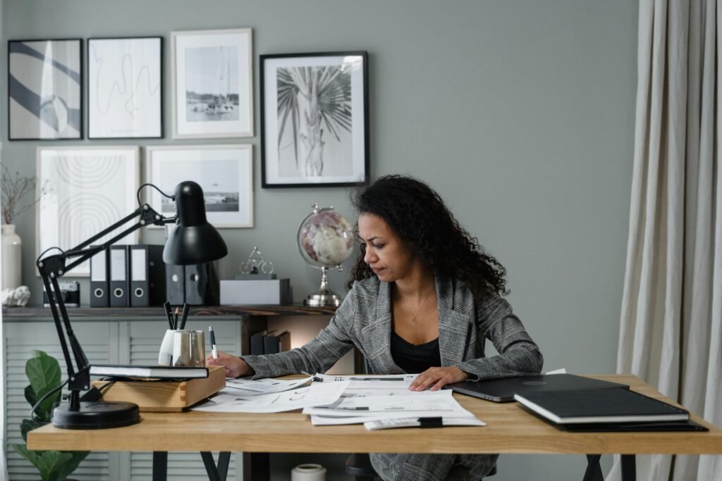 pexels-photo-6694529-6694529 Businesswoman evaluates documents at a modern desk in a stylish office setting.